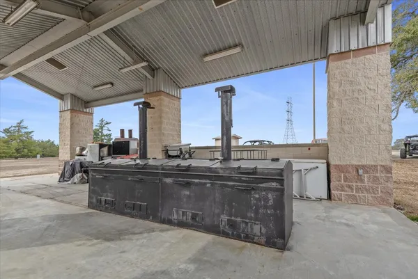 a large kitchen with stainless steel appliances wooden cabinets a dining table and chairs