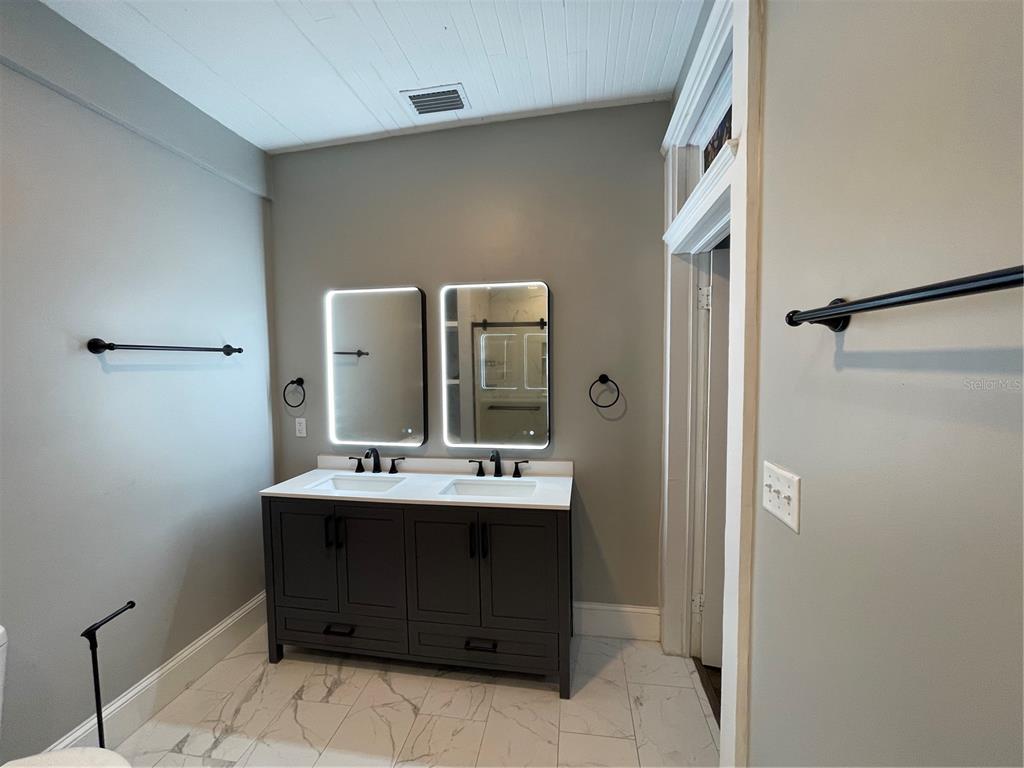 1932 West Spruce Street Tampa, FL 33607 - Photo 11 of 24 a bathroom with a sink a mirror and a toilet