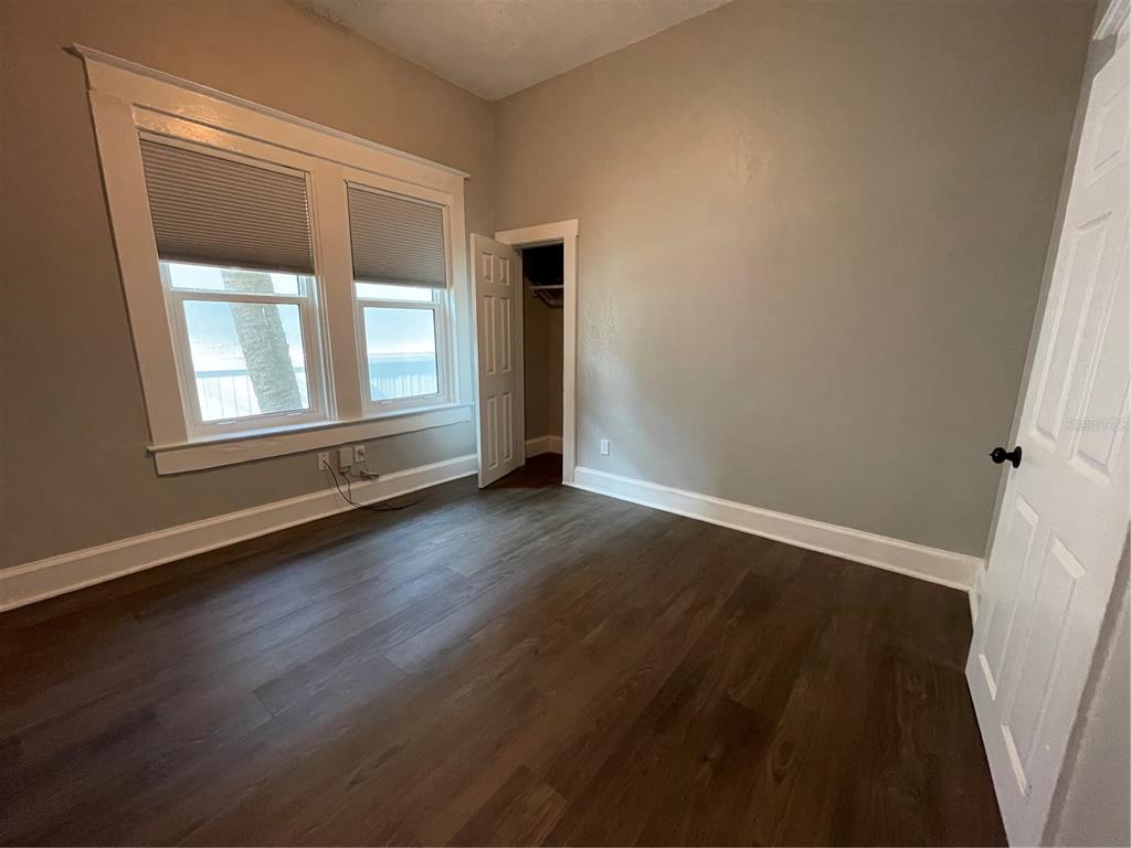1932 West Spruce Street Tampa, FL 33607 - Photo 12 of 24 an empty room with wooden floor and windows