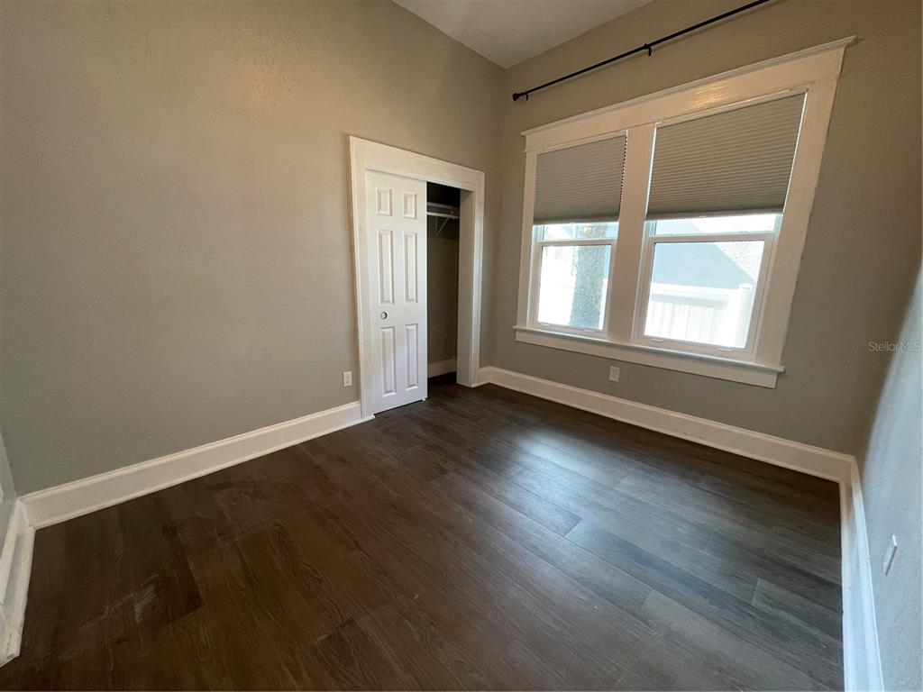 1932 West Spruce Street Tampa, FL 33607 - Photo 15 of 24 an empty room with wooden floor and windows