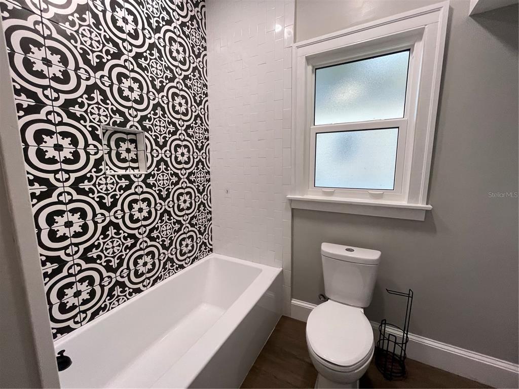 1932 West Spruce Street Tampa, FL 33607 - Photo 16 of 24 a white toilet sitting next to a bathroom sink