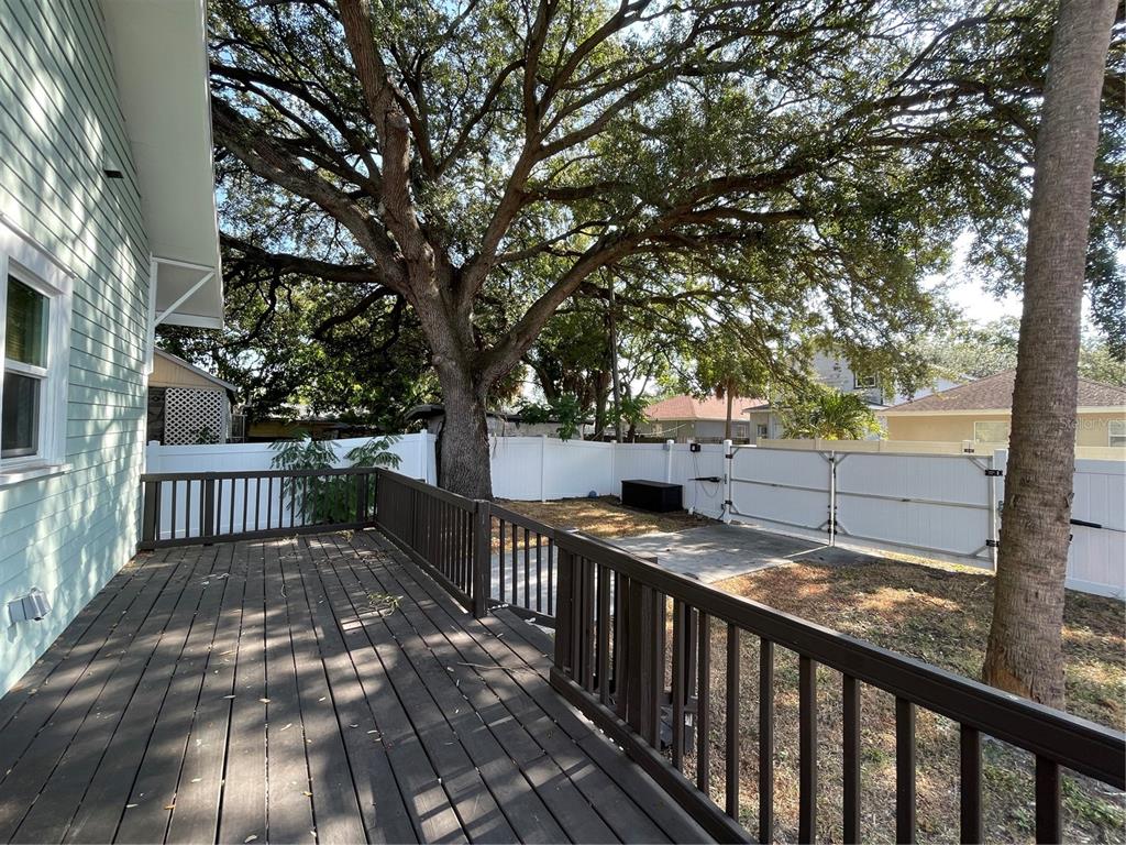 1932 West Spruce Street Tampa, FL 33607 - Photo 22 of 24 a view of balcony with wooden floor and fence
