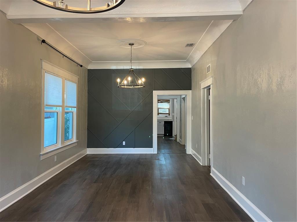 1932 West Spruce Street Tampa, FL 33607 - Photo 3 of 24 wooden floor in an empty room with a window