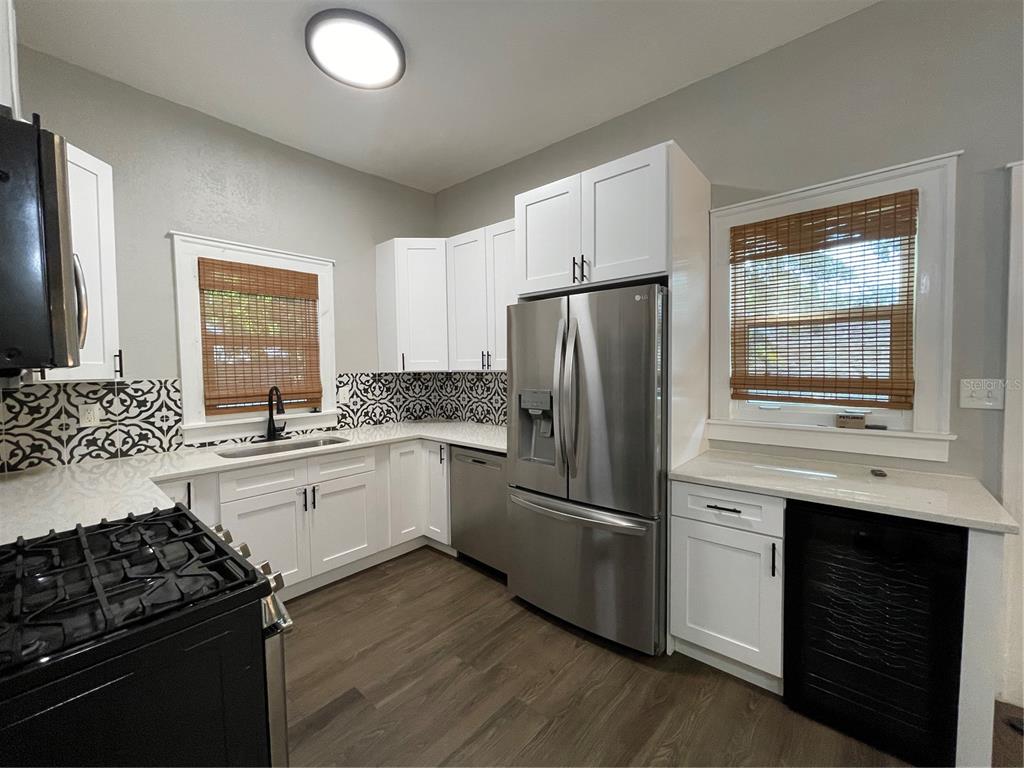1932 West Spruce Street Tampa, FL 33607 - Photo 4 of 24 a kitchen with a refrigerator stove and sink