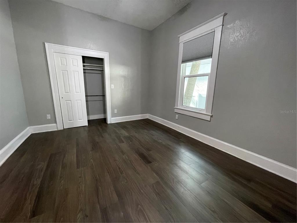 1932 West Spruce Street Tampa, FL 33607 - Photo 8 of 24 an empty room with wooden floor and windows