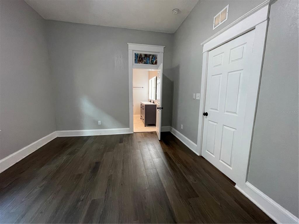 1932 West Spruce Street Tampa, FL 33607 - Photo 9 of 24 a view of a room with wooden floor and a window
