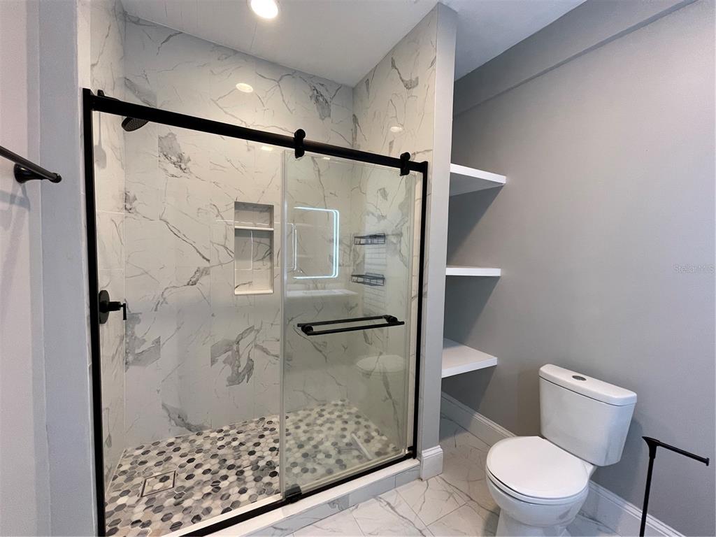 1932 West Spruce Street Tampa, FL 33607 - Photo 10 of 24 a bathroom with a shower and toilet
