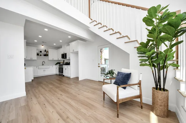 a kitchen with white cabinets and white appliances