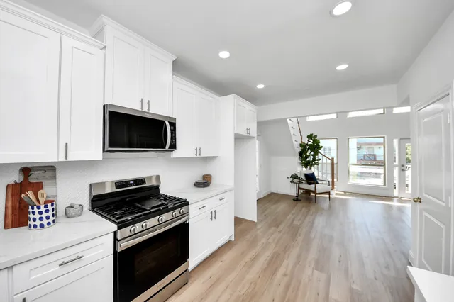 a kitchen with a sink a refrigerator and cabinets