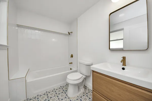 a bathroom with a sink a toilet and mirror