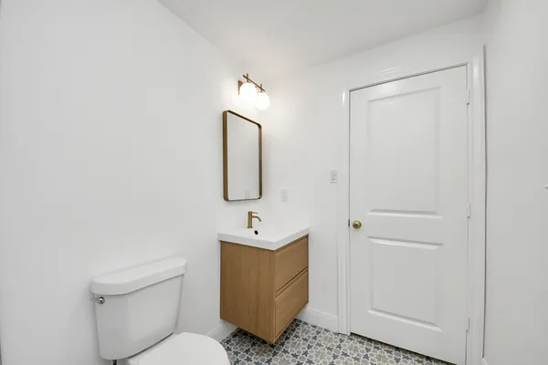 a bedroom with a bed and a lamp