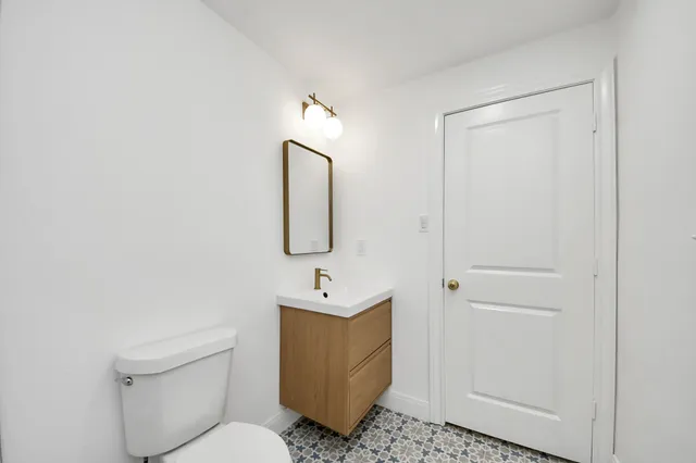 a bedroom with a bed and a lamp