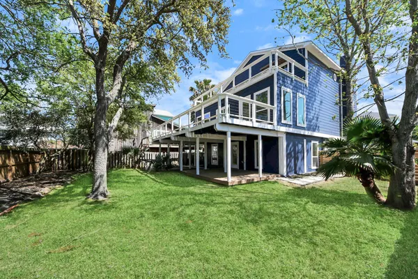 a spacious bedroom with a bed and wooden floor