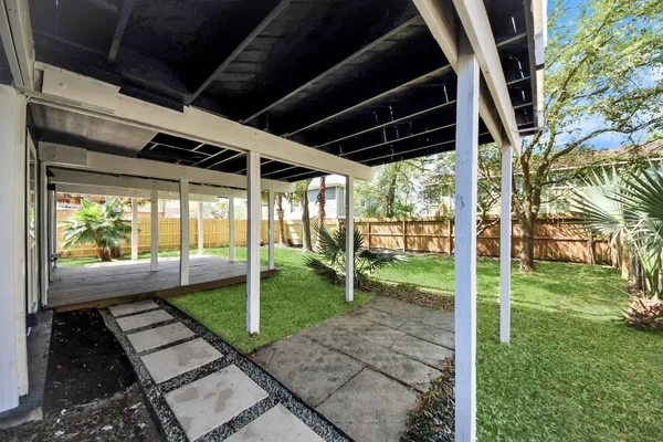 a view of a house with a yard and sitting area