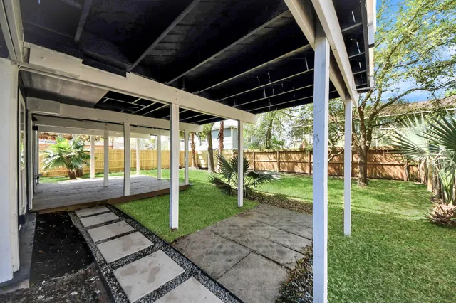 a view of a house with a yard and sitting area