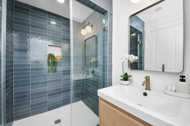 a bathroom with a sink mirror and toilet