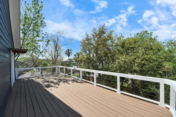 a view of backyard with wooden floor and potted plants