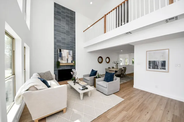 a living room with furniture and a fireplace
