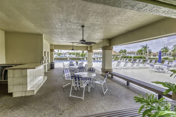a view of a swimming pool with an outdoor seating