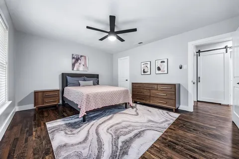 a bedroom with a bed and a chandelier