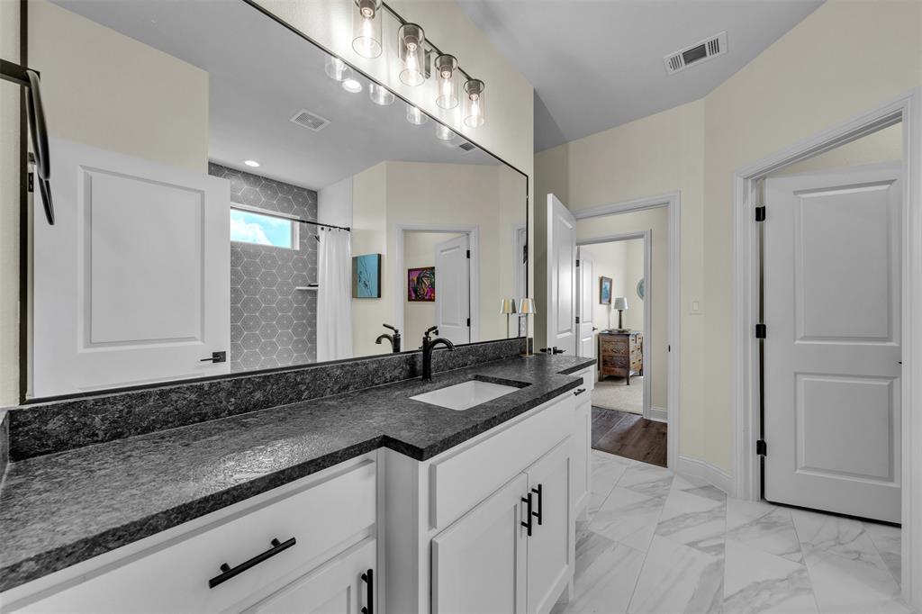 6628 Buffalo Ridge Circle Godley, TX 76044 - Photo 15 of 39 a bathroom with a granite countertop sink and a mirror