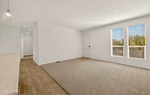 a view of a room with wooden floor and outdoor space