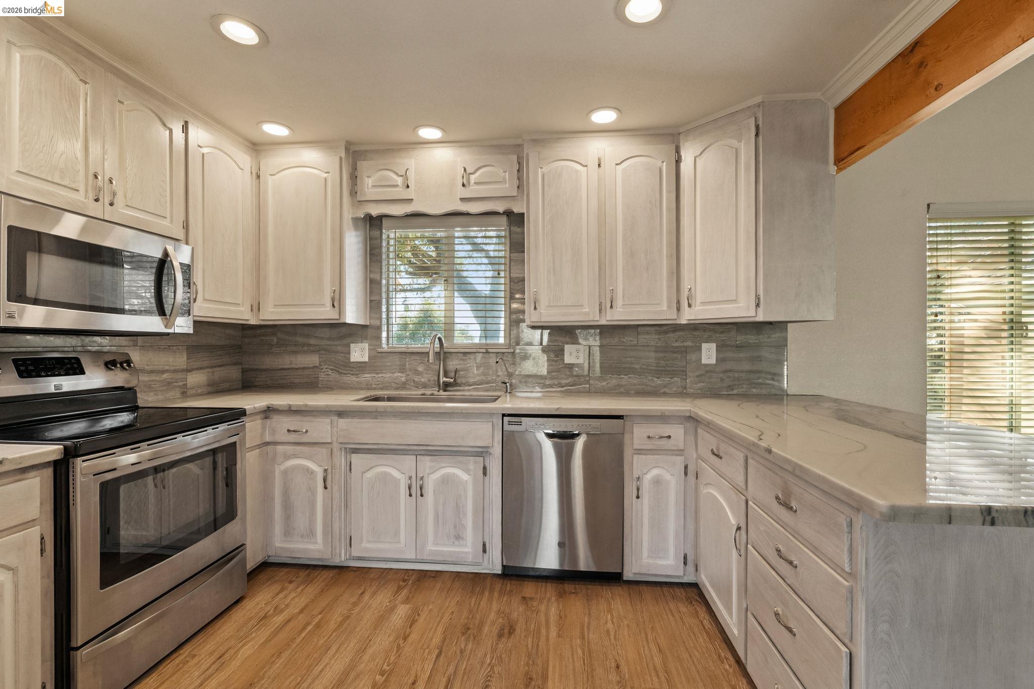 21916 Phoenix Lake Road Sonora, CA 95370 - Photo 11 of 48 a kitchen with stainless steel appliances granite countertop a stove a sink and a microwave