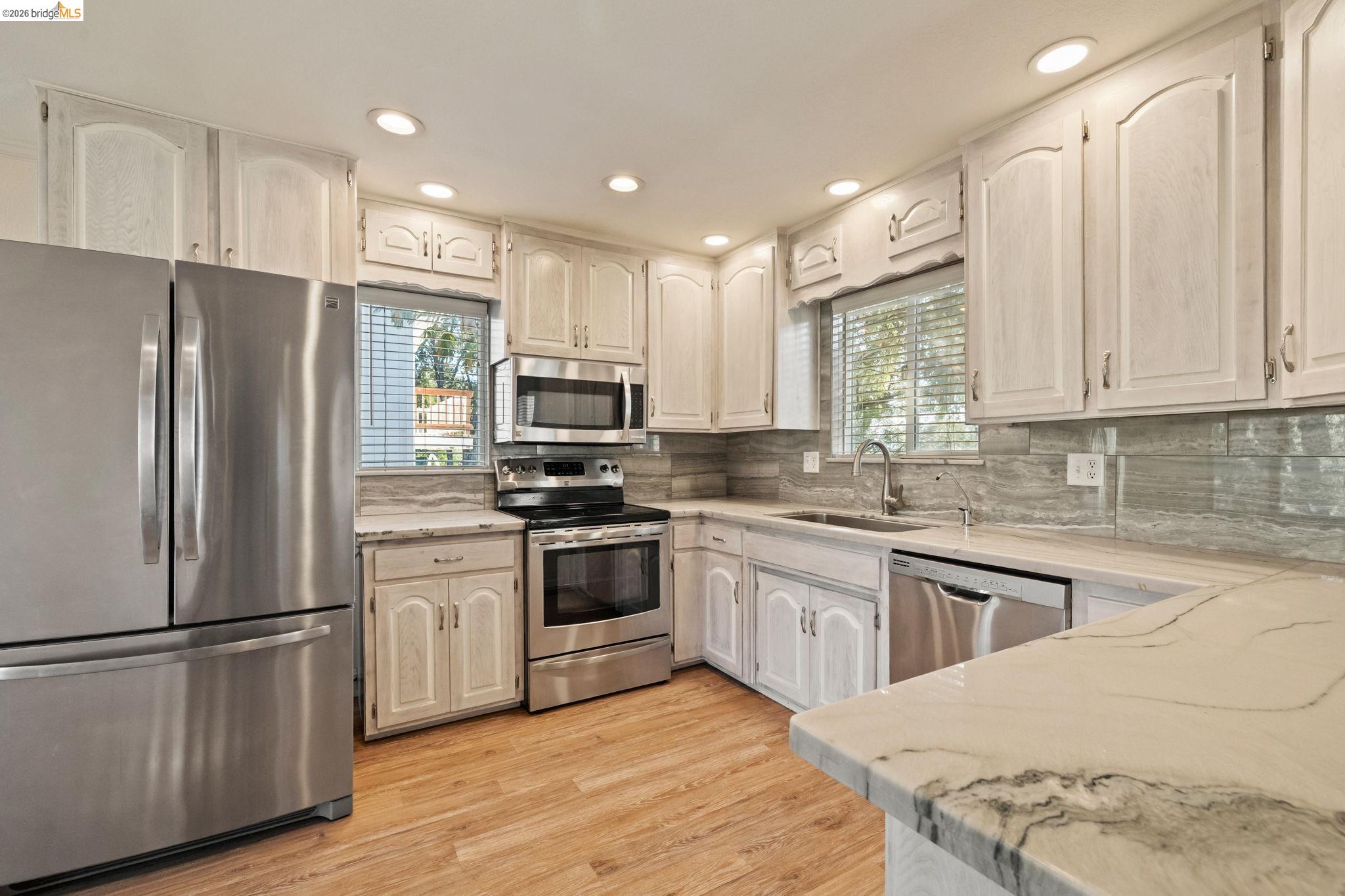 21916 Phoenix Lake Road Sonora, CA 95370 - Photo 12 of 48 a kitchen with stainless steel appliances granite countertop a refrigerator stove microwave and sink