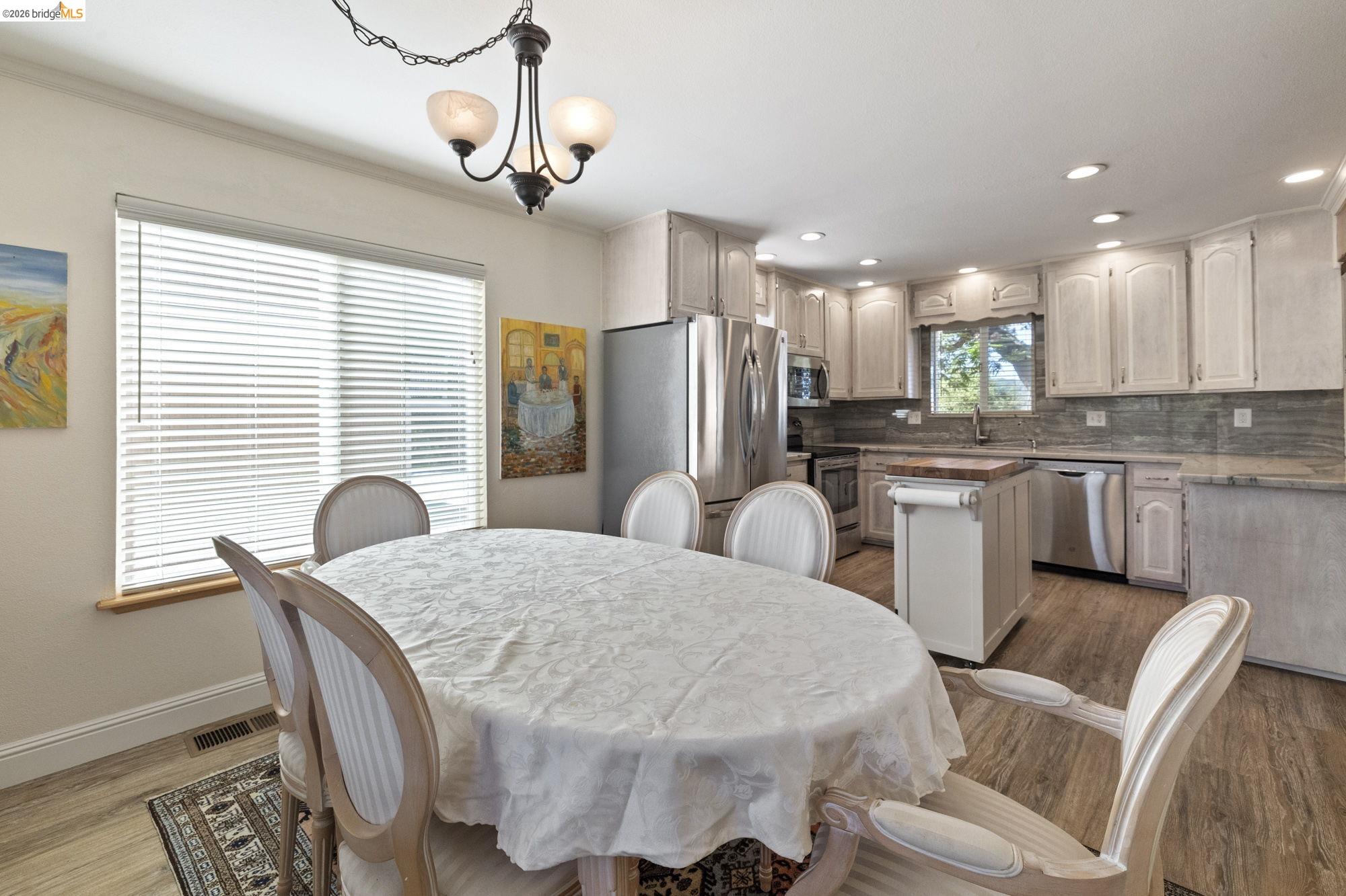21916 Phoenix Lake Road Sonora, CA 95370 - Photo 14 of 48 a kitchen with stainless steel appliances granite countertop a dining table chairs and a refrigerator