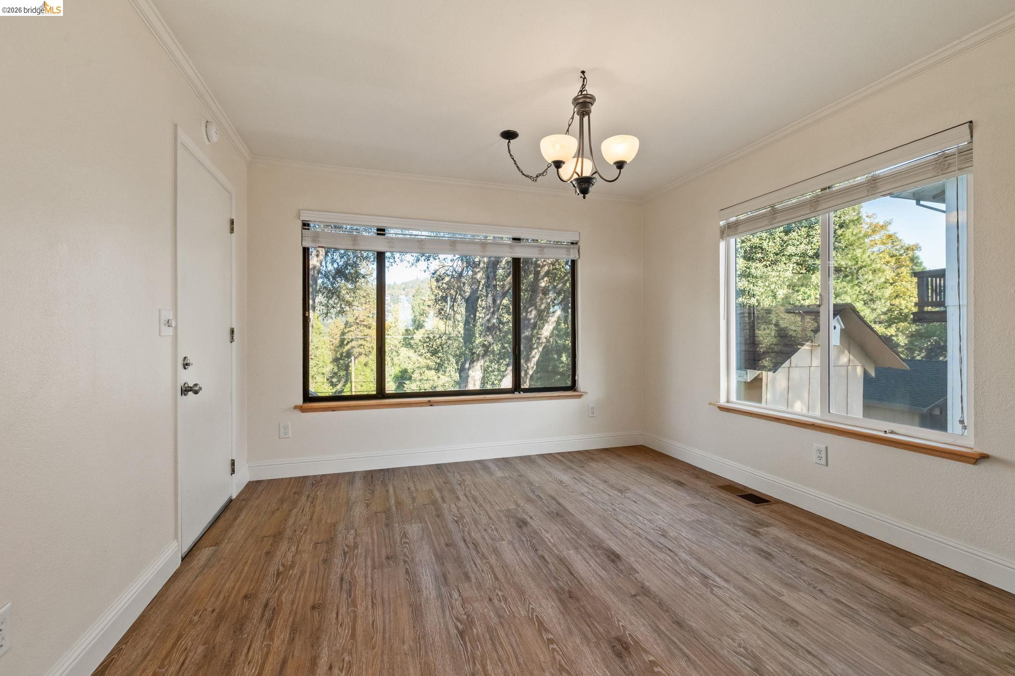 21916 Phoenix Lake Road Sonora, CA 95370 - Photo 15 of 48 wooden floor in an empty room with a window