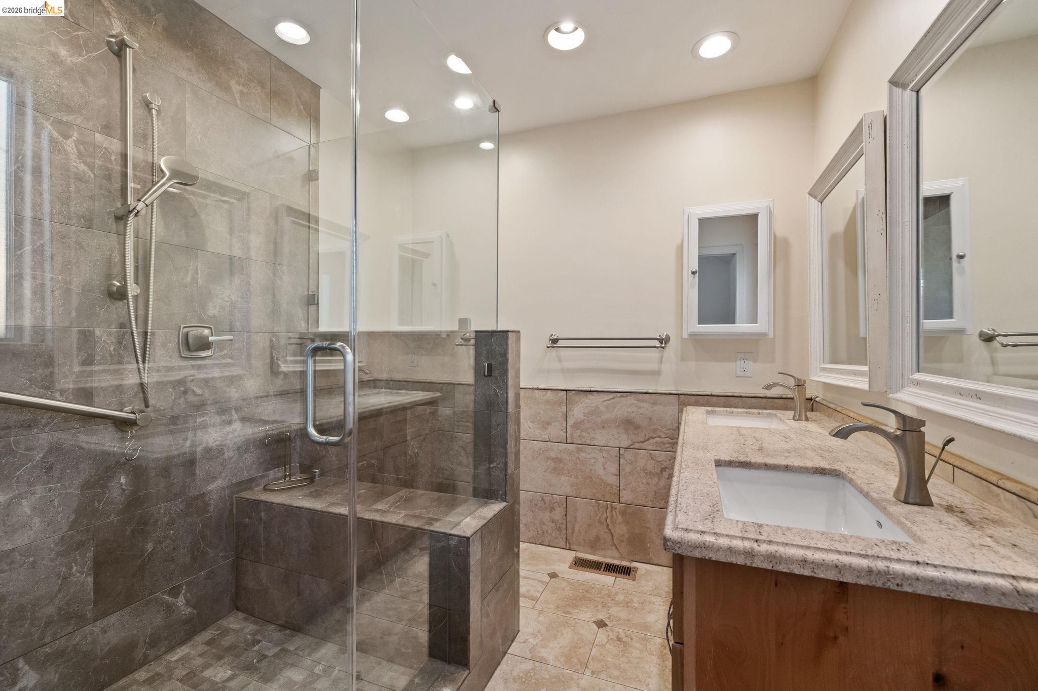 21916 Phoenix Lake Road Sonora, CA 95370 - Photo 16 of 48 a bathroom with a granite countertop sink a mirror and shower