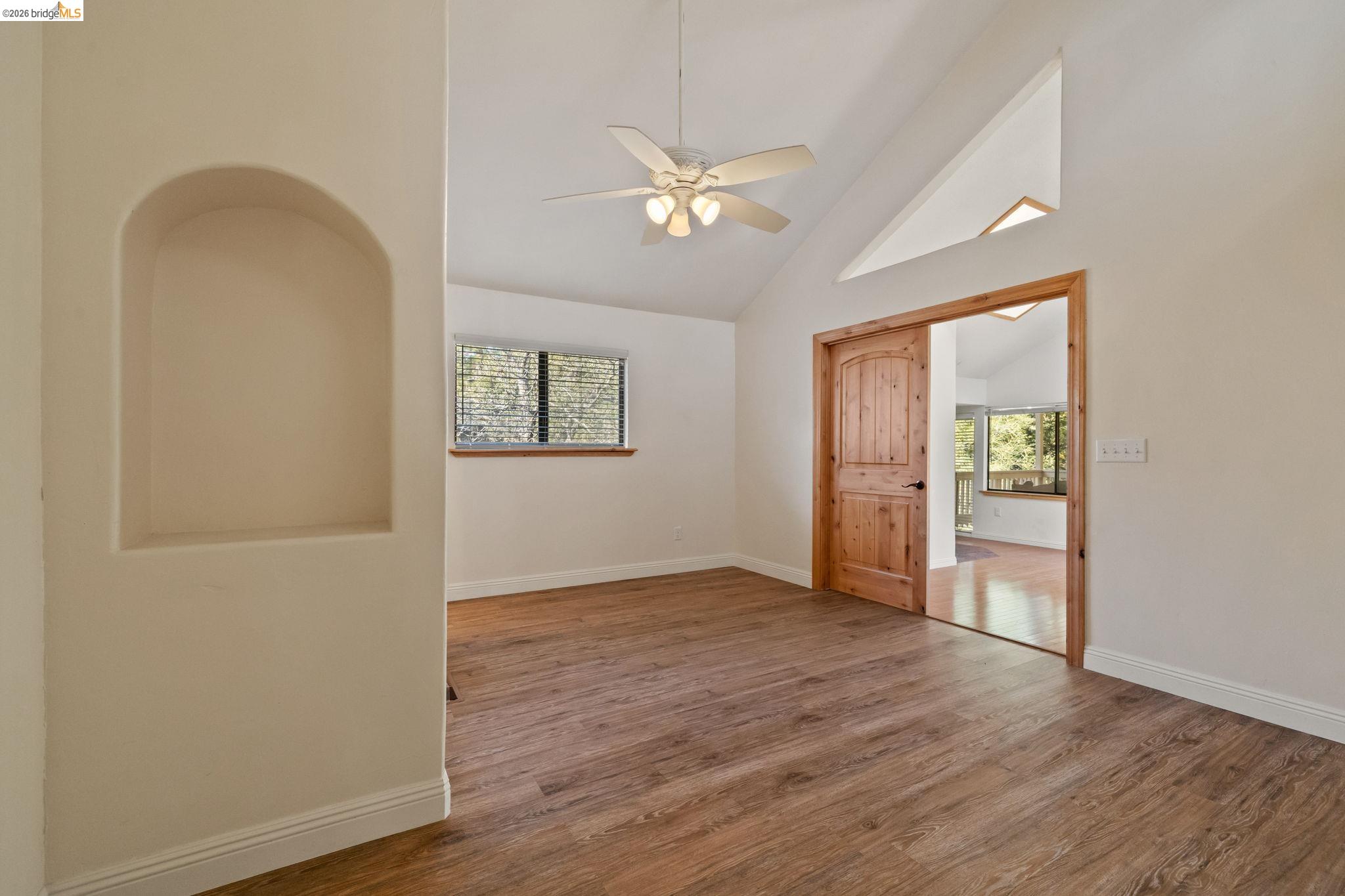 21916 Phoenix Lake Road Sonora, CA 95370 - Photo 20 of 48 a view of an empty room with wooden floor and a window