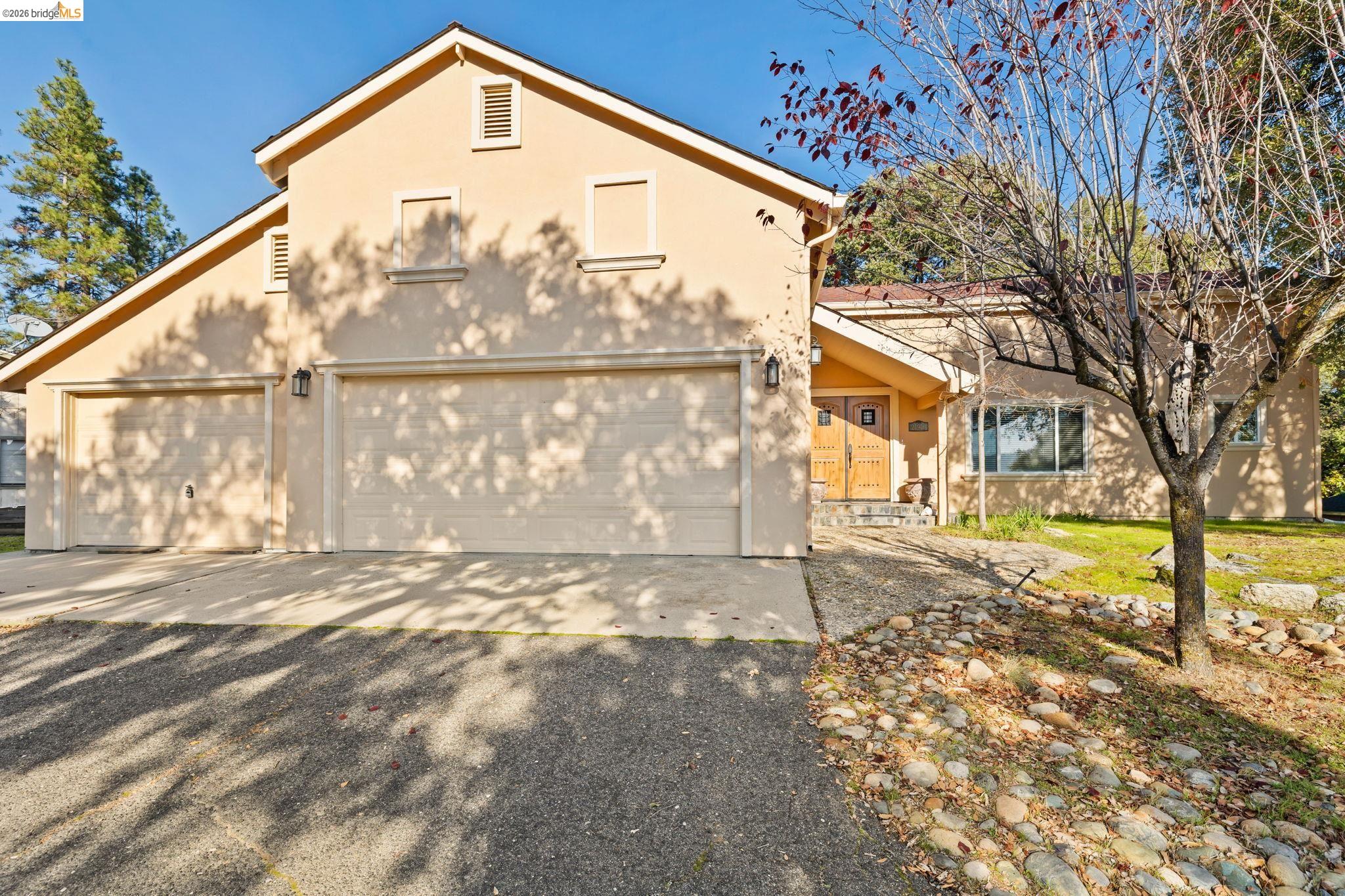 21916 Phoenix Lake Road Sonora, CA 95370 - Photo 2 of 48 a front view of a house with a yard and garage