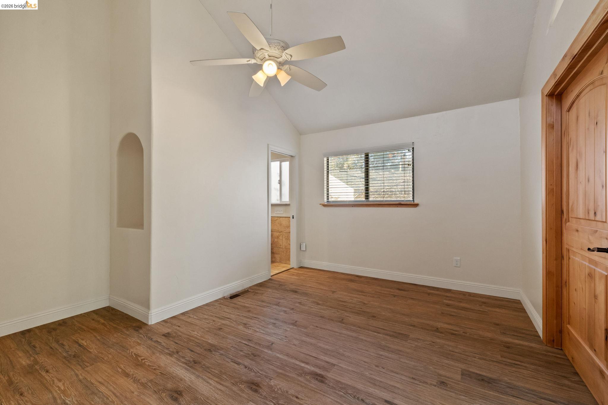 21916 Phoenix Lake Road Sonora, CA 95370 - Photo 21 of 48 an empty room with wooden floor fan and windows