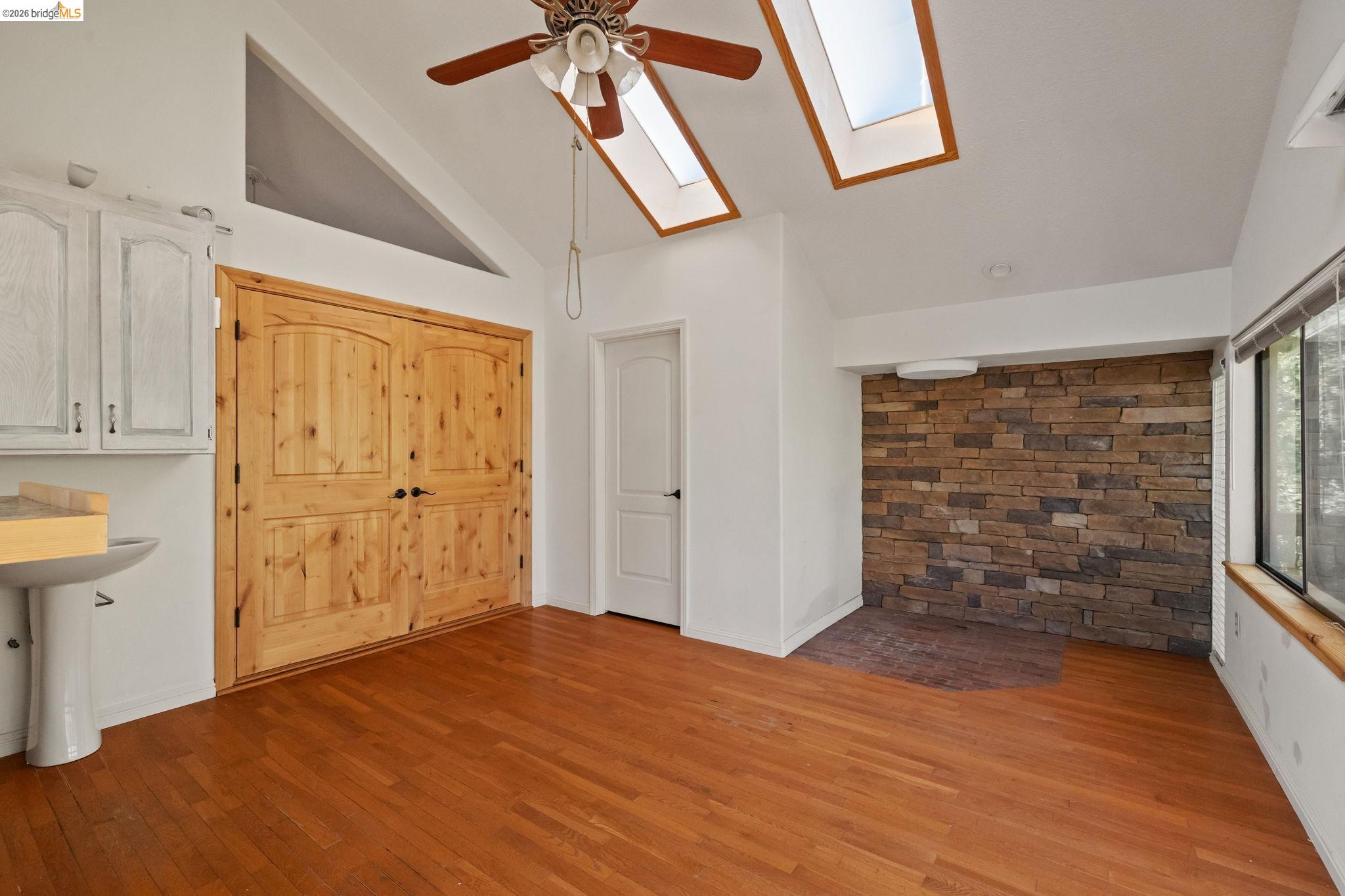 21916 Phoenix Lake Road Sonora, CA 95370 - Photo 24 of 48 a view of empty room with wooden floor and fan