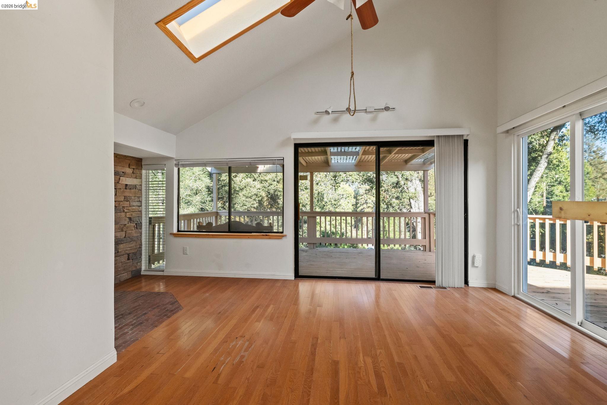 21916 Phoenix Lake Road Sonora, CA 95370 - Photo 25 of 48 a view of an empty room with wooden floor and a window
