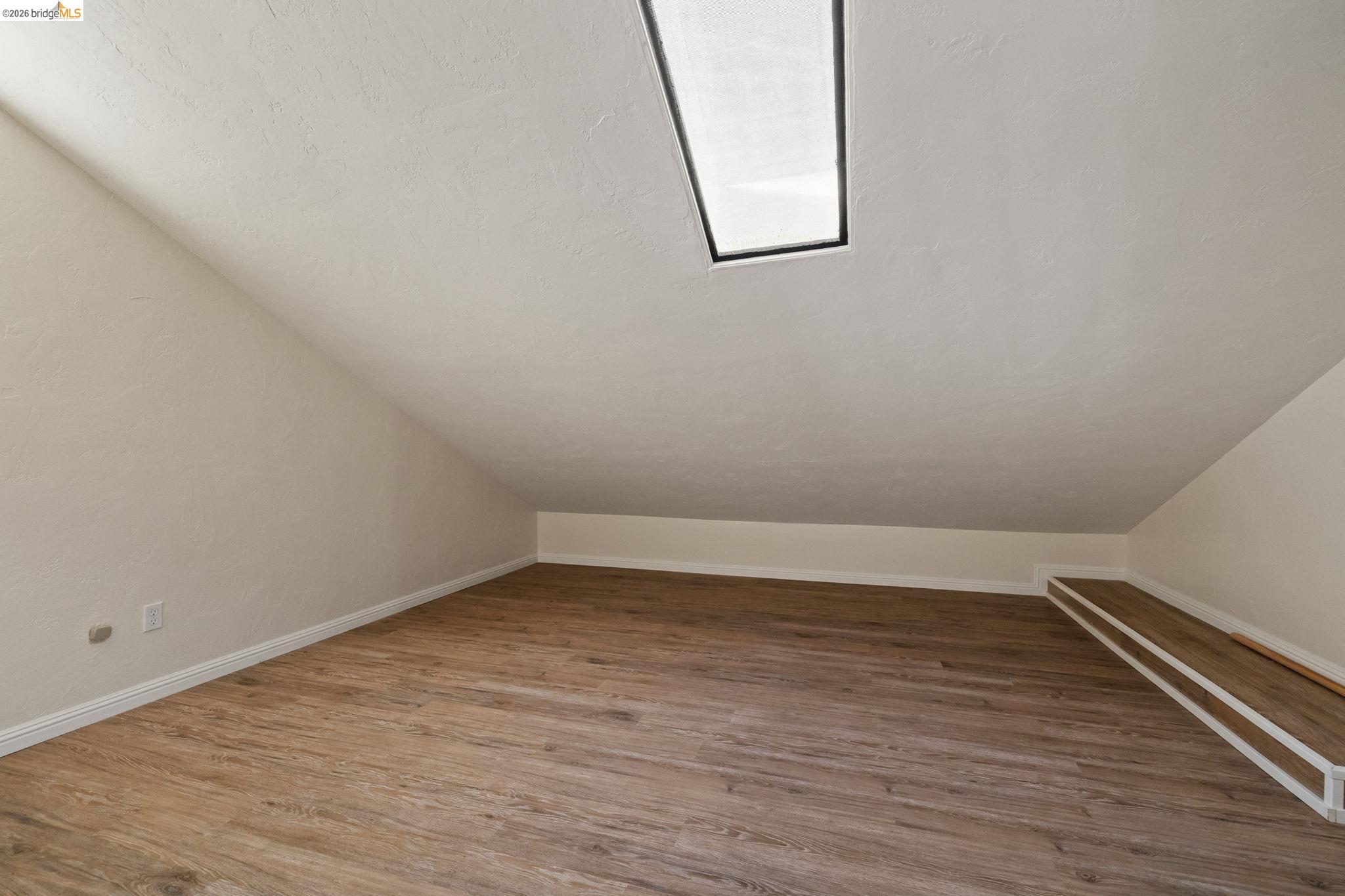 21916 Phoenix Lake Road Sonora, CA 95370 - Photo 35 of 48 a view of an empty room with wooden floor and a window