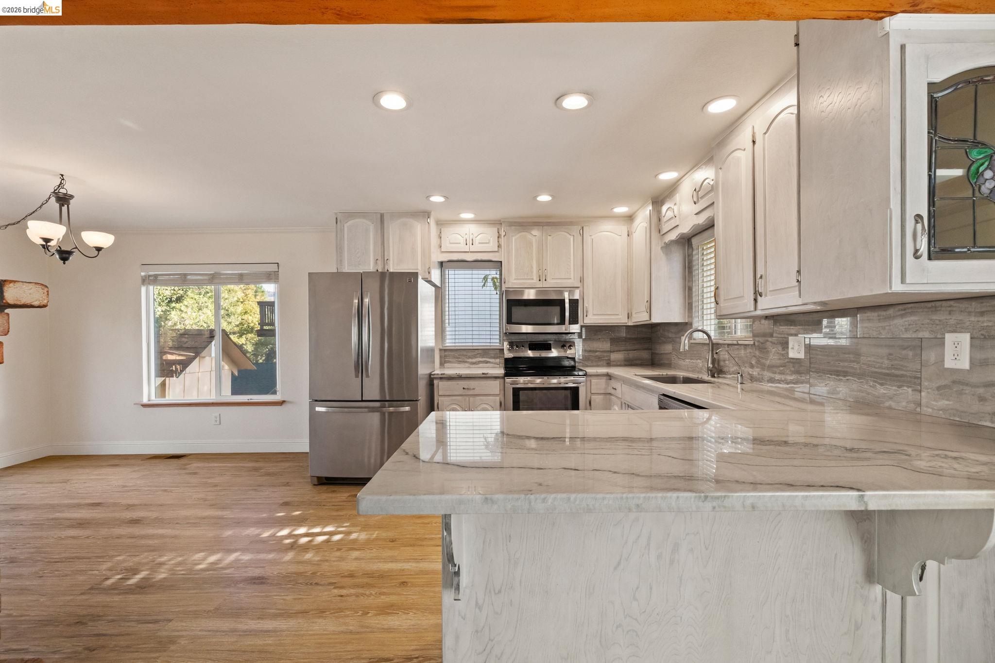 21916 Phoenix Lake Road Sonora, CA 95370 - Photo 9 of 48 a kitchen with stainless steel appliances granite countertop a sink refrigerator and cabinets