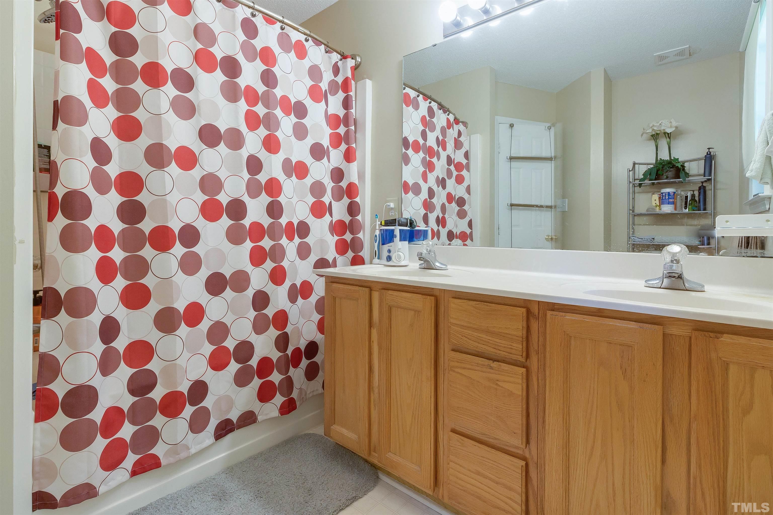 4204 Archibald Way Raleigh, NC 27616 - Photo 11 of 23 a bathroom with a sink mirror and shower
