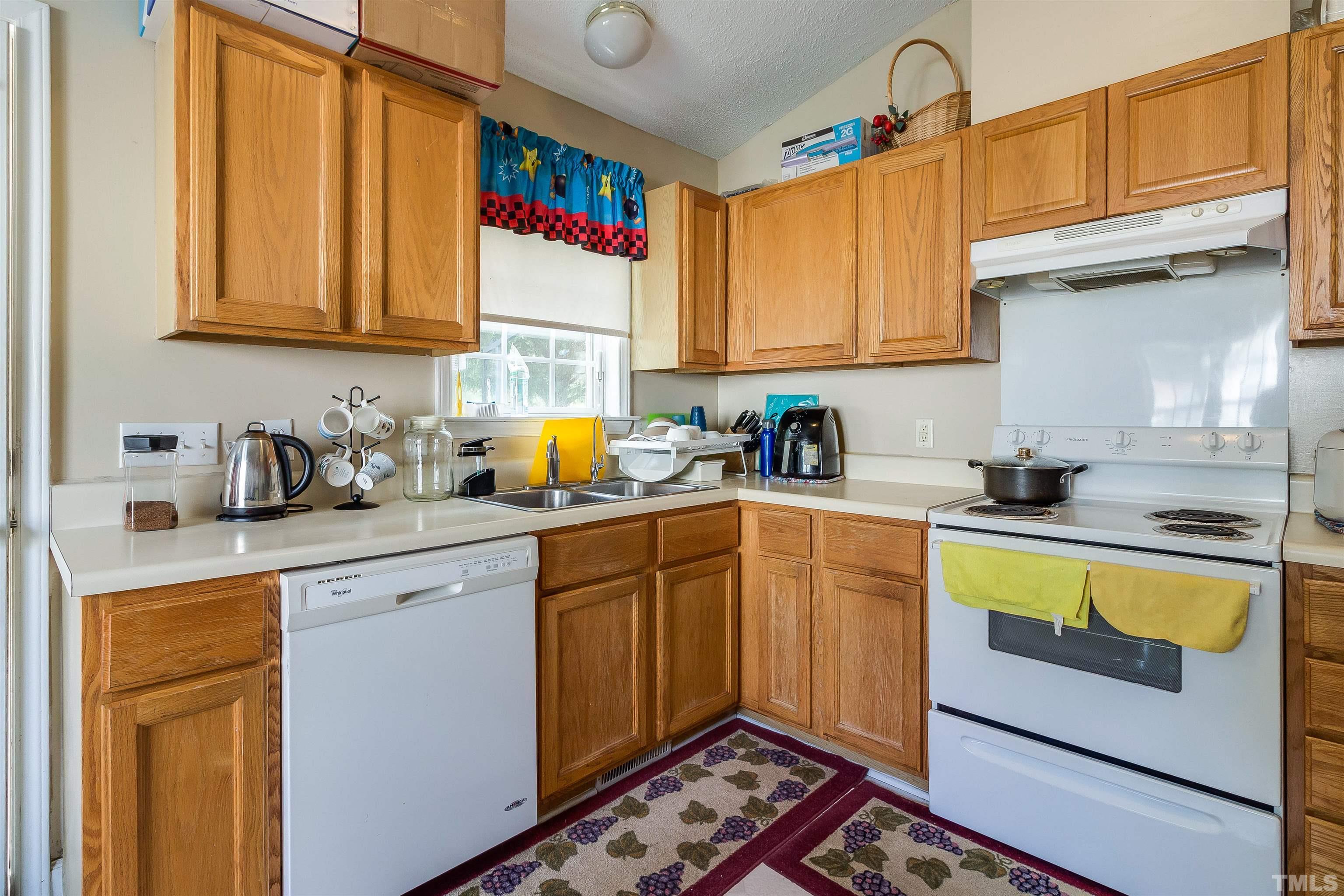 4204 Archibald Way Raleigh, NC 27616 - Photo 4 of 23 a kitchen with a sink cabinets and appliances