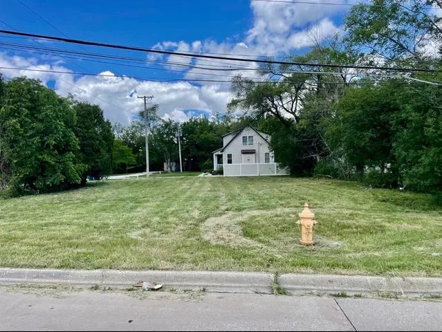 a view of a wooden fence with a yard