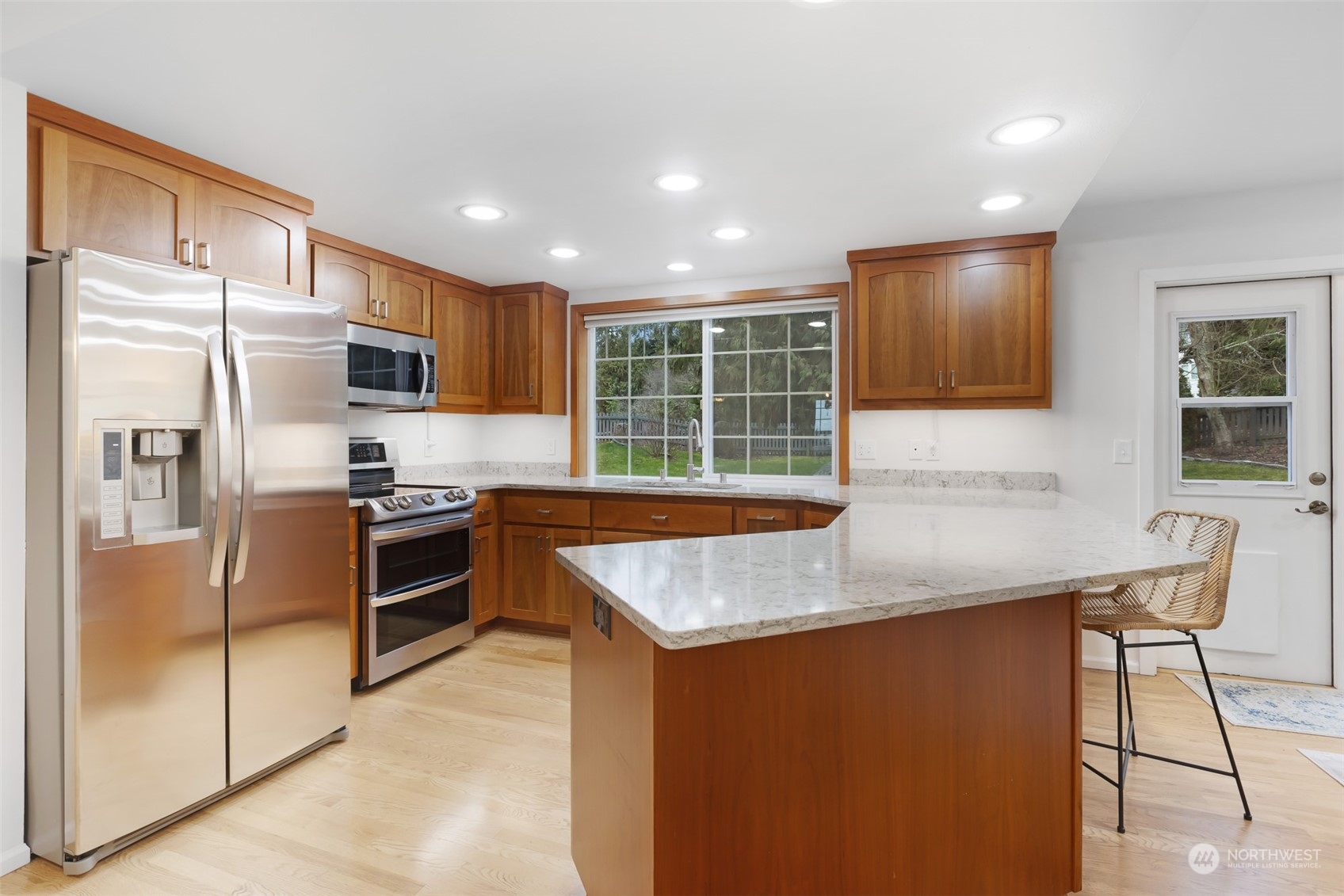443 Doe Run Road Sequim, WA 98382 - Photo 6 of 39 a kitchen with stainless steel appliances granite countertop a refrigerator a sink a stove a microwave and island
