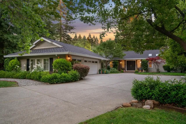 a front view of a house with a yard and outdoor seating