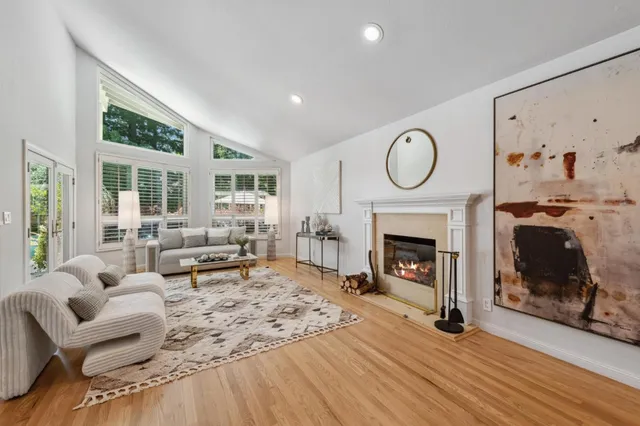 a view of a dining room with furniture wooden floor and a chandelier