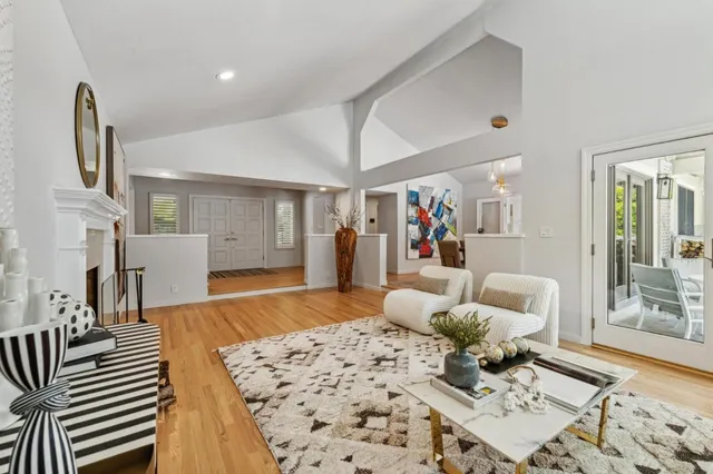 a kitchen with stainless steel appliances granite countertop hardwood floor sink stove dining table and chairs