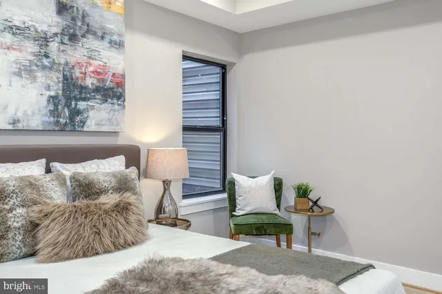 a bedroom with a bed and window