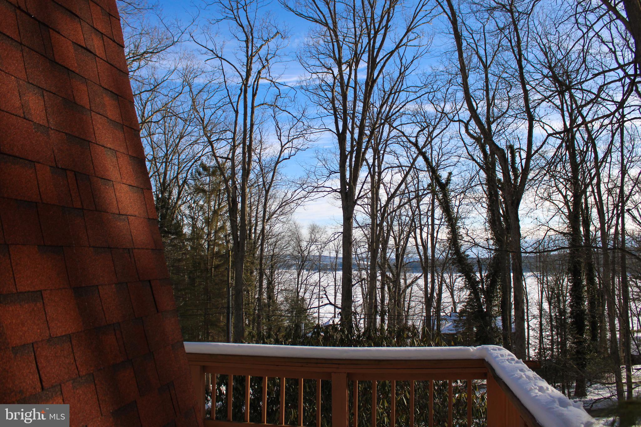 135 Glen Cove Road Swanton, MD 21561 - Photo 5 of 15 a view of a white house with a large tree and wooden fence