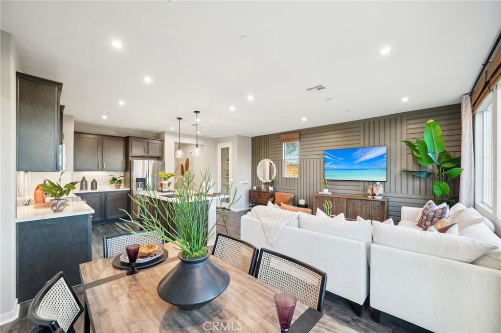 a living room with furniture a window and a potted plant