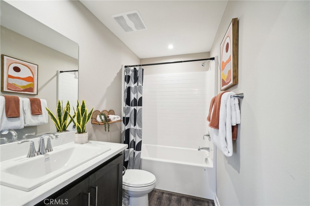 16051 Montenegro Lane Fontana, CA 92336 - Photo 12 of 17 a bathroom with a granite countertop sink toilet and shower