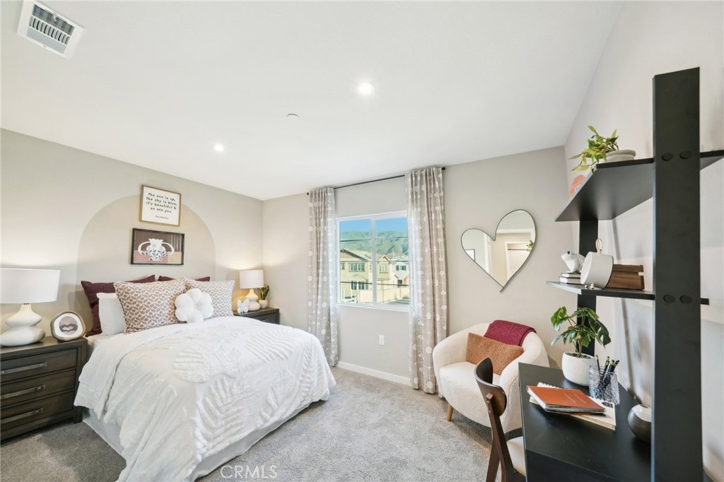 16051 Montenegro Lane Fontana, CA 92336 - Photo 14 of 17 a bedroom with a bed and window